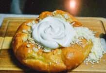 ⭐ Langos Recipe That Ruined Me puffy golden langos sitting on a wooden cutting board.