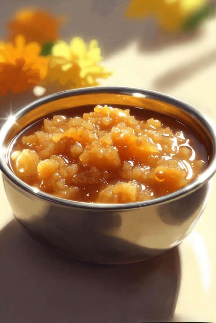a steel bowl filled with glossy, golden-brown Gurudwara Karah Prasad. a steel bowl filled with glossy, golden-brown Gurudwara Karah Prasad.