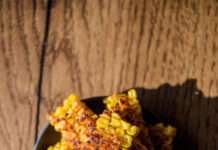 Crispy Corn Kebabs That’ll Make You Forget About Fries a plate of crispy corn kebabs on a textured wooden table, warm lighting, a little shadow on the right for depth.